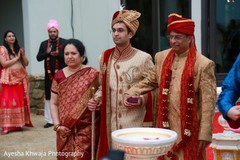 Indian groom escorted by bridals parents. Indian groom escorted by bridals parents.