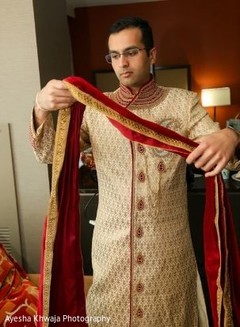 Indian groom on his golden and red ceremony outfit. Indian groom on his golden and red ceremony outfit.