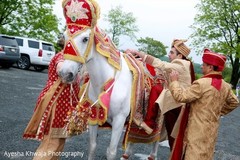 Indian groom getting onto his white baraat horse. Indian groom getting onto his white baraat horse.
