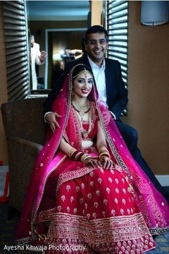 Indian bride ready for her wedding ceremony posing with relative. Indian bride ready for her wedding ceremony posing with relative.