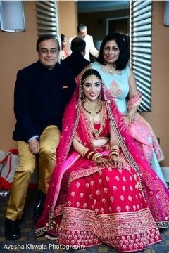 Indian bride on her ceremony lehenga with relatives photography. Indian bride on her ceremony lehenga with relatives photography.