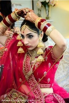 Indian bride getting her Maang Tikka on. Indian bride getting her Maang Tikka on.