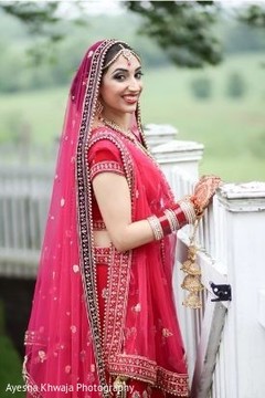 Indian bride on her re golden ghoonghat. Indian bride on her re golden ghoonghat.