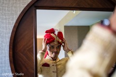 Indian groom putting red turban. Indian groom putting red turban.