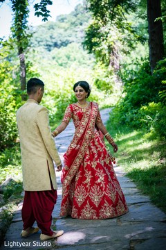 Indian groom wearing red dhoti greeting his maharani. Indian groom wearing red dhoti greeting his maharani.