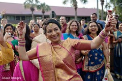 Indian wedding guest on her golden and magenta saree. Indian wedding guest on her golden and magenta saree.