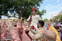 Indian groom lifted at baraat procession. Indian groom lifted at baraat procession.
