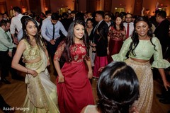 Indian bridesmaids dancing at reception party. Indian bridesmaids dancing at reception party.