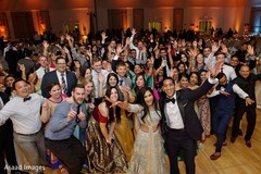 Indian couple posing with Indian wedding guests capture. Indian couple posing with Indian wedding guests capture.