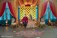 Enchanting Indian couple posing at Sangeet stage. Enchanting Indian couple posing at Sangeet stage.