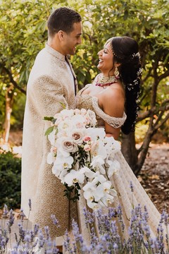 Indian couple with Indian flowers bouquet during photo session. Indian couple with Indian flowers bouquet during photo session.