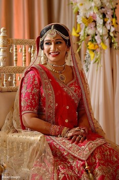 Indian bride on her red lehenga with her ceremony jewelry. Indian bride on her red lehenga with her ceremony jewelry.