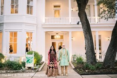 Indian couple holding hands by the Indian wedding venue. Indian couple holding hands by the Indian wedding venue.