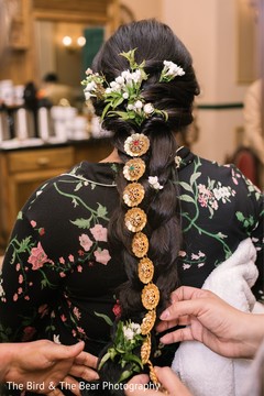 Indian bride being assisted by hair and makeup artist. Indian bride being assisted by hair and makeup artist.