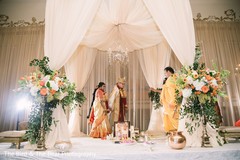 Indian bride and Maharani holding hands under mandap. Indian bride and Maharani holding hands under mandap.