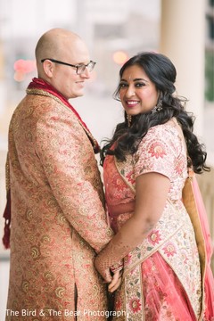 Indian groom and bride holding hands during the photoshoot. Indian groom and bride holding hands during the photoshoot.