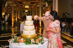 Indian groom cutting the Indian wedding cake with Maharani. Indian groom cutting the Indian wedding cake with Maharani.