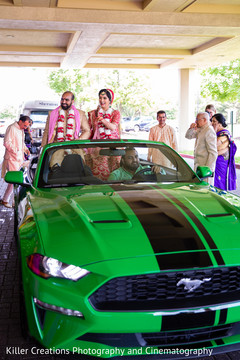 Indian couple leaving the venue in a green Mustang. Indian couple leaving the venue in a green Mustang.