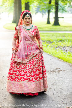 Indian bride wearing a red lengha saree for her Hindu wedding. Indian bride wearing a red lengha saree for her Hindu wedding.