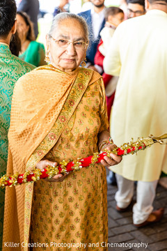 Indian relative holding Indian's groom cane. Indian relative holding Indian's groom cane.