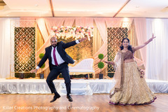 Indian groom wearing a suit with his bride in Anarkali dancing. Indian groom wearing a suit with his bride in Anarkali dancing.