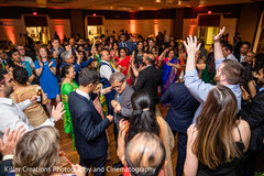 Indian guests dancing in the Hindu wedding reception party. Indian guests dancing in the Hindu wedding reception party.