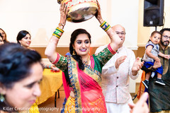Indian bride lifting a basket during the sangeet. Indian bride lifting a basket during the sangeet.