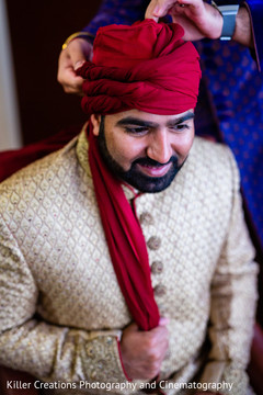 Indian groom being assisted with his turban. Indian groom being assisted with his turban.