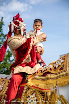 Indian groom holding an Indian child during his Baraat. Indian groom holding an Indian child during his Baraat.