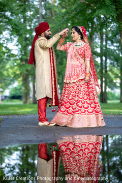 Maharani and Indian groom playing around during photo session. Maharani and Indian groom playing around during photo session.