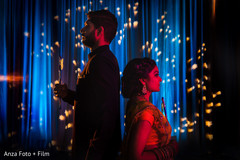 Indian couple posing with dandiya sticks at sangeet. Indian couple posing with dandiya sticks at sangeet.
