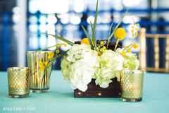 Golden Indian wedding Sangeet candles and flowers table decorations. Golden Indian wedding Sangeet candles and flowers table decorations.