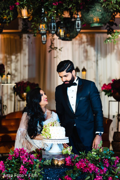 Indian couple about to cut their wedding cake. Indian couple about to cut their wedding cake.