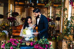 Indian newlyweds cutting the cake capture Indian newlyweds cutting the cake capture
