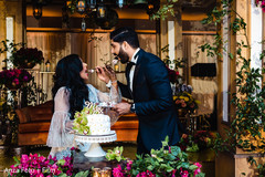 Indian wedding cutting the cake scene Indian wedding cutting the cake scene