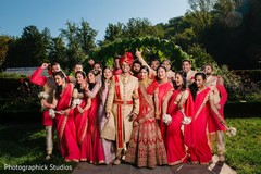 Indian couple posing with groomsmen and bridesmaids outdoors. Indian couple posing with groomsmen and bridesmaids outdoors.