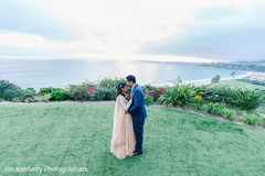 Indian groom kissing his Maharani in a garden. Indian groom kissing his Maharani in a garden.