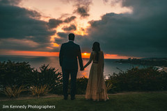 Indian couple holding hands in front of the sunset. Indian couple holding hands in front of the sunset.