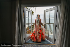 Indian bride with hindu wedding outfit by the window. Indian bride with hindu wedding outfit by the window.