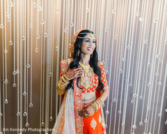 Indian bride with red lengha and golden jewelry. Indian bride with red lengha and golden jewelry.