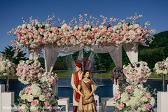 Indian couple at mandap on their golden and red ceremony outfits. Indian couple at mandap on their golden and red ceremony outfits.