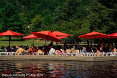 Outdoors Indian wedding guests covered with red umbrellas. Outdoors Indian wedding guests covered with red umbrellas.