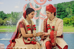 Maharani putting wedding ring to groom capture. Maharani putting wedding ring to groom capture.