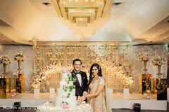Lovely capture Indian bride and groom cutting cake together. Lovely capture Indian bride and groom cutting cake together.
