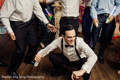 Indian groom performing a dance at reception party. Indian groom performing a dance at reception party.
