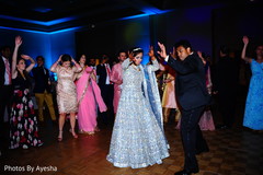 Indian bride dancing with her Indian groom in the reception party. Indian bride dancing with her Indian groom in the reception party.