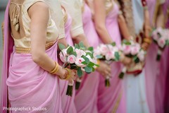closeup capture of Indian bridesmaids pink bouquets. closeup capture of Indian bridesmaids pink bouquets.