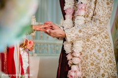 Indian groom putting ring to bride capture. Indian groom putting ring to bride capture.