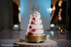 White and golden with roses Indian wedding cake. White and golden with roses Indian wedding cake.
