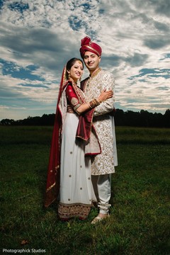 Indian couple posing outdoors on their ceremony outfits. Indian couple posing outdoors on their ceremony outfits.
